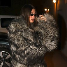 Photo of Hailey Bieber wearing fur coat and leggings.