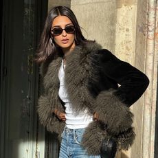 Salome Mory wearing faux-fur trimmed jacket and sunglasses