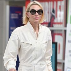 Cate Blanchett wears a white jumpsuit to the airport