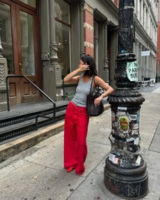 woman wearing red pants and slippers in NYC