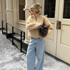 woman wearing neutral outerwear outfit with jeans